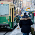 People getting on a tram in winter.