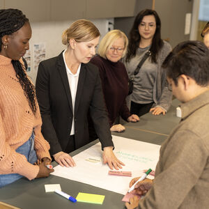 People gathered around a table and discussing.