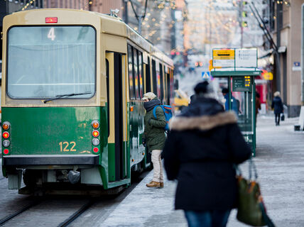People getting on a tram in winter.