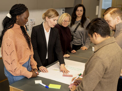 People gathered around a table and discussing.