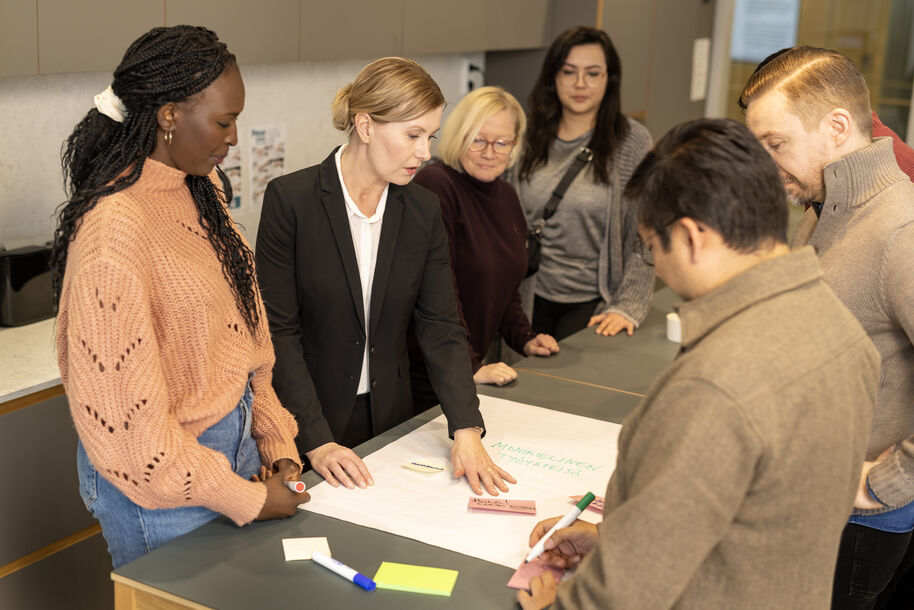 People gathered around a table and discussing.
