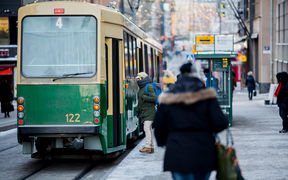 People getting on a tram in winter.