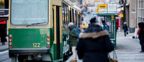 People getting on a tram in winter.